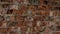 Close-up pattern of textured background of old abandoned red brick wall with empty space.