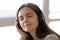 Close up peaceful woman in headphones enjoying favorite music