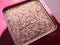 A close-up of pearlescent shimmery pink eyeshadow for creating eye makeup.  Beauty concept