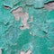 Close-up of peeling painted wall. Rustic green grunge material.