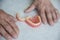 close-up of a pensioner\'s hand and removable dentures lying on the table, selective focus. problem with teeth,