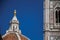 Close-up of people on the dome of the Santa Maria del Fiore Cathedral and Giotto`s Campanile in Florence.