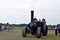 A close up of people driving  a steam engine