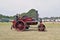 A close up of people driving  a steam engine