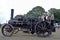 A close up of people driving  a steam engine