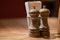 Close-Up Of Pepper Salt Seasoning Wooden Glinders On Table. Salt and pepper shakers on wooden table