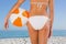 Close up of perfect young womans buttocks with beach ball