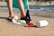 Close Up Of Person Collecting Plastic Waste From Polluted Beach Using Litter Picker