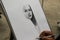 Close up of a person drawing a beautiful sketch of a beautiful girl