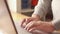 Close up of person fingers typing on laptop, business or education