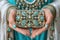 A close-up of a person gracefully holding a fashionable purse, showcasing intricate details and elegant design. The