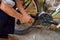 Close-up Of Person Hands Lubricating Bike Chain