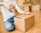 Close up of person hands packing cardboard box