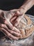 A close up of a person holding a loaf of bread. Generative AI image.