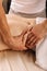 Close-up of a person receiving shiatsu treatment from a massager. Masseur presses fingers on points