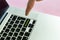 Close up person`s hand finger pushing the `hashtag` text on a button of laptop keyboard isolated concept f