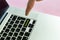 Close up person`s hand finger pushing the `subscribe` text on a button of laptop keyboard isolated concept v