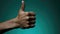 A close up of a person& x27;s hand giving a thumbs up. Generative AI image.