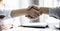 A close-up of a person shaking hands, two businessmen shaking hands after agreeing to sign a business investment contract together