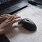 A close-up of a persons hand using a 3D mouse to navigate one generative AI