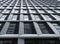 Close up perspective detail of tall high rise modern apartment building with geometric white cladding and dark windows