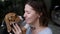 Close up of a pet beagle kissing a woman, love animals concept. Dog licking her owner nose.