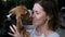 Close up of a pet beagle kissing a woman, love animals concept. Dog licking her owner nose.