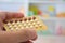 Close up of pharmacist hands holding contraceptive pills