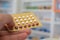 Close up of pharmacist hands holding contraceptive pills