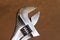 Close up photo of an adjustable crescent wrench on brown background with copyspace