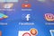 A close-up photo of Apple iPhone start screen with â€˜Facebook` apps icon
