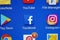 A close-up photo of Apple iPhone start screen with â€˜Facebook` apps icon