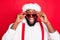 Close up photo of astonished african santa claus touching his specs screaming wow omg see noel miracle wearing stylish