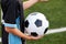 Close-up photo of ball in hands of football player