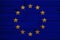 Close-up photo of beautiful colored stylized European Union flag, symbol of united Europe on textured fabric, concept of tourism,