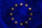 Close-up photo of beautiful colored stylized European Union flag, symbol of united Europe on textured fabric, concept of tourism,