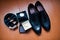 Close-up photo of black groom`s brogue shoes, watch, wedding rin