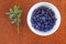 Close up photo of blueberries on plate. Fresh ripe juicy bilberries, bright autumn colorful background. Concept for healthy diet w