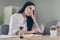 Close up photo of bored woman broker looking waiting browsing internet indoor workstation