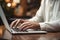 Close-up photo of businessman typing on laptop.