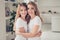 Close up photo cheer toothy smiling two people mum and teen daughter holding hands arms around chest lovely looking best