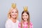 Close up photo cheer two people blond haired she her granny little daughter weekend activities crowns on head stars wear