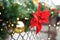 Close-up photo of Christmas and New Year decorations. Fence decorated with a garland of artificial fir branches with red flowers