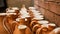 Close-up photo of clay jugs. Rows of handmade earthenware jugs. Handicraft