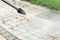 Close up photo of a cleaning a tile of grass in his yard. High pressure cleaning