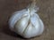 Close up photo of compound bulb containing cloves. Close up Photo of Organic Whole Garlic on chopping board.