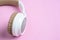 Close-up photo of cool headphone on pink background. Music concept