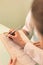 Close-up photo of Doctor signing on clipboard while receptionist standing at clinic