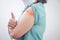 Close-up photo of an elderly woman vaccinated against coronavirus with orange plaster covering a wound on her left arm.