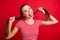 Close up photo of excited cheerful nice funny girlfriend wearing striped t-shirt while isolated with red background